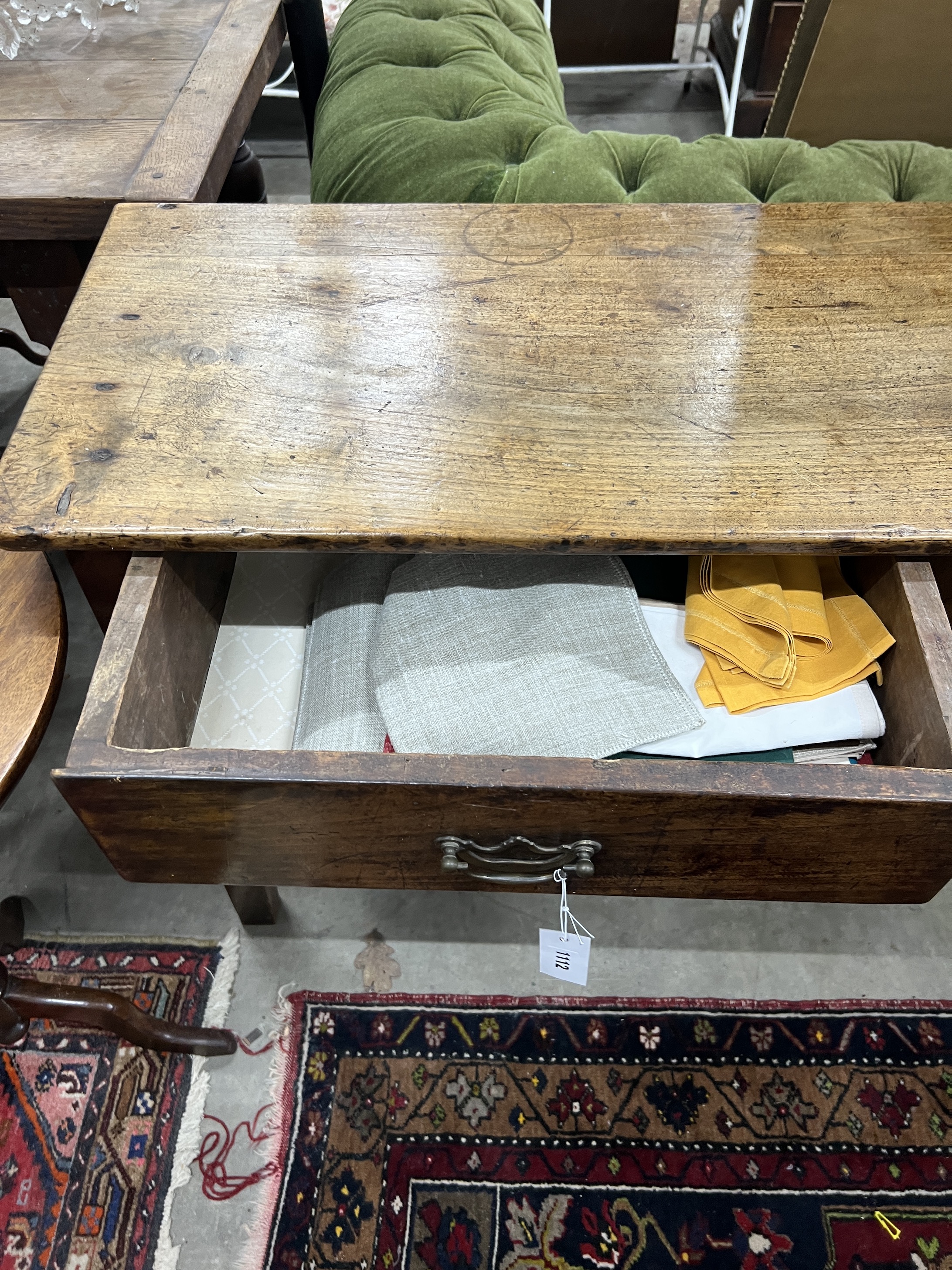 An 18th century elm and fruitwood three drawer low dresser, width 185cm, depth 43cm, height 76cm
